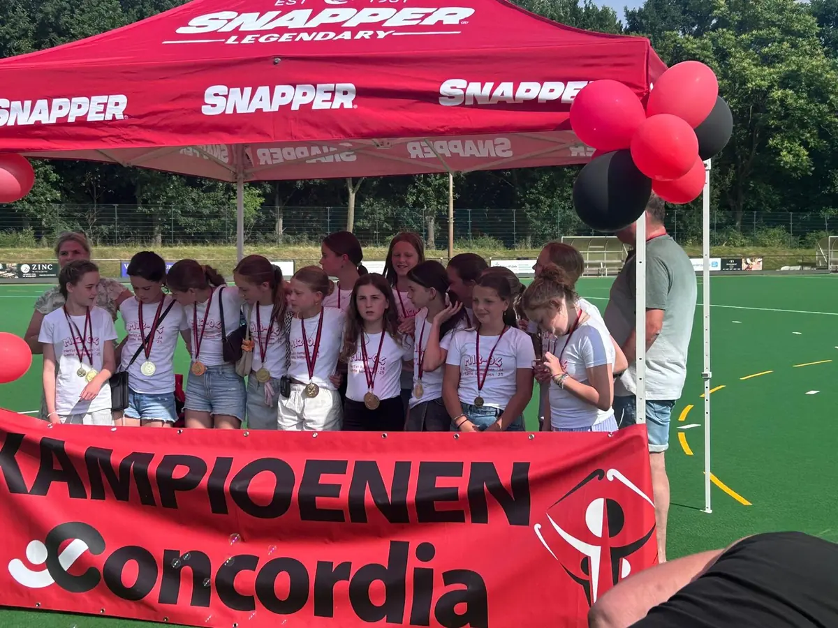 Hockeyteam van Concordia in witte kampioensshirts